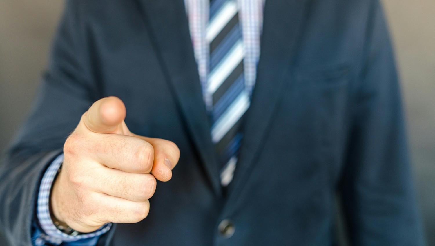 Manager pointing at the camera.